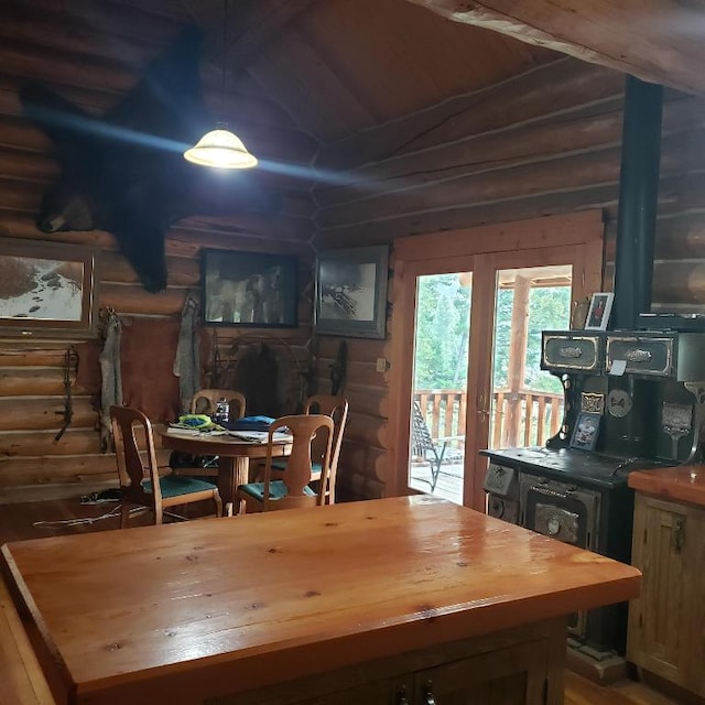 dining area featuring rustic walls and french doors