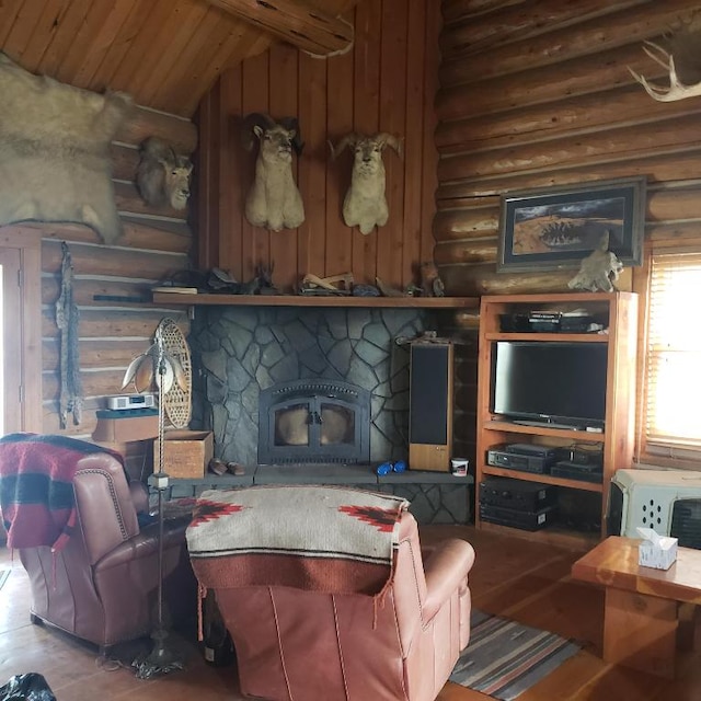 living room featuring rustic walls, lofted ceiling, a stone fireplace, and wood-type flooring