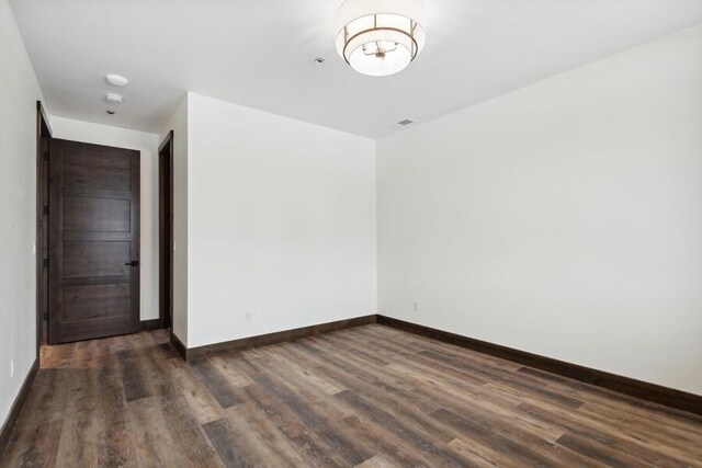 empty room with dark hardwood / wood-style floors