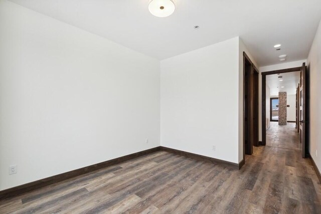 spare room with dark hardwood / wood-style flooring