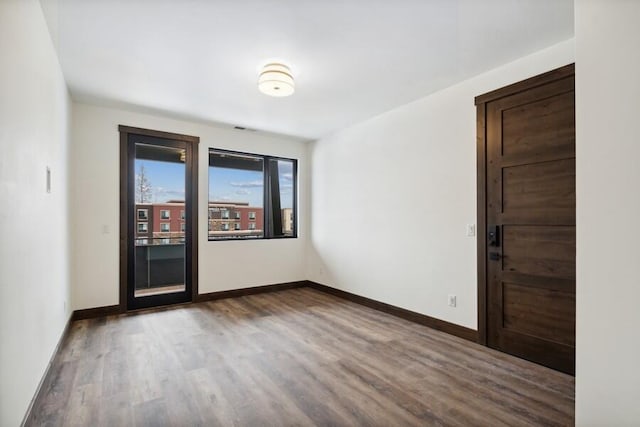 spare room featuring wood-type flooring