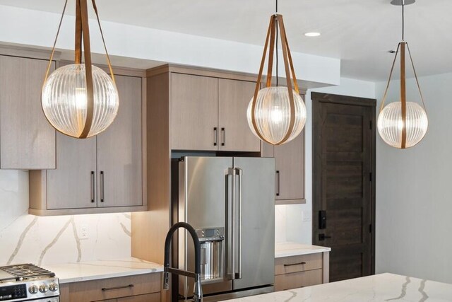 kitchen with light brown cabinets, tasteful backsplash, stainless steel fridge with ice dispenser, and light stone countertops