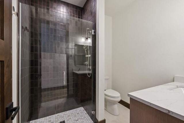 bathroom with tile patterned flooring, an enclosed shower, vanity, and toilet