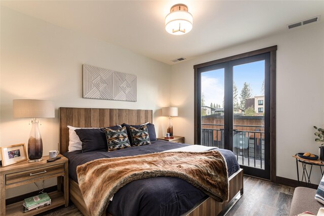 bedroom with access to exterior and dark hardwood / wood-style flooring