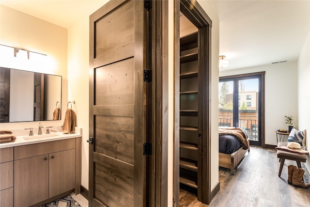 bathroom with vanity and hardwood / wood-style floors