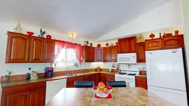 kitchen featuring white appliances, sink, and lofted ceiling