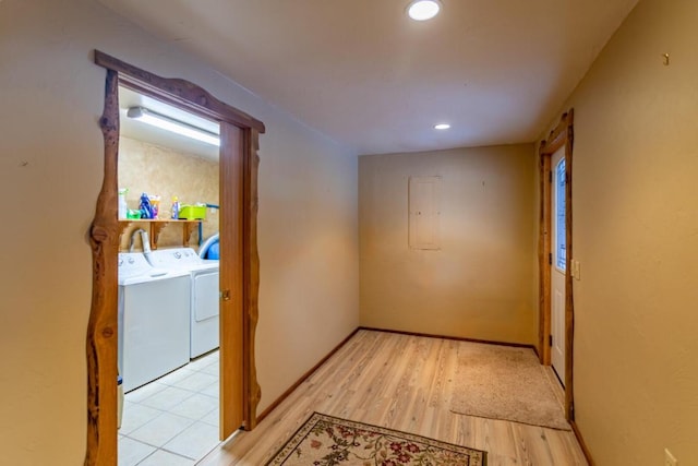 hall featuring light tile floors and washing machine and dryer