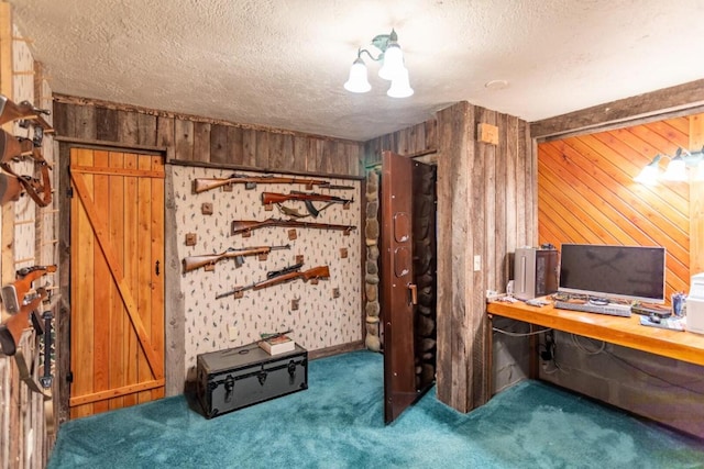 carpeted home office with wooden walls and a textured ceiling