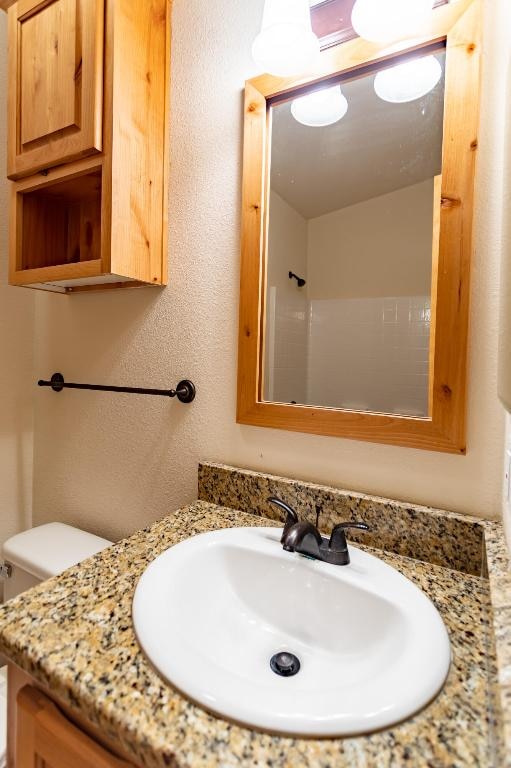 bathroom featuring toilet and vanity