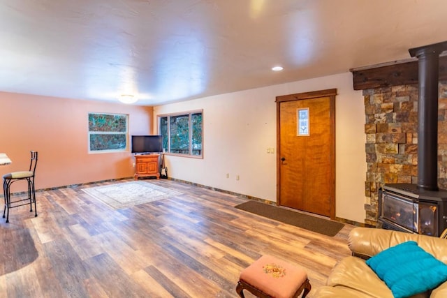 living room with a wood stove and dark wood-type flooring