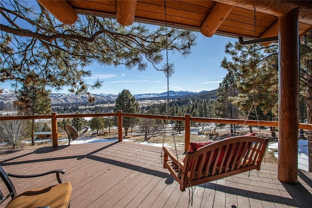 snow covered deck featuring a mountain view