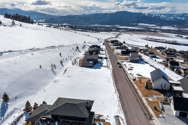 snowy aerial view with a mountain view