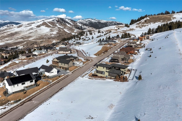 snowy aerial view featuring a mountain view