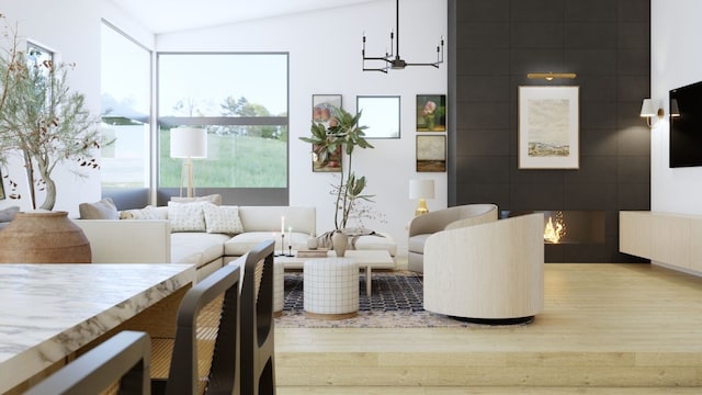 living room featuring hardwood / wood-style floors, a notable chandelier, and lofted ceiling