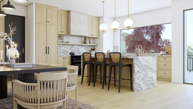 interior space featuring plenty of natural light, light hardwood / wood-style floors, and decorative light fixtures
