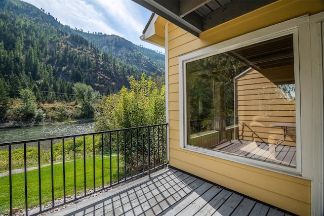 balcony featuring a water and mountain view