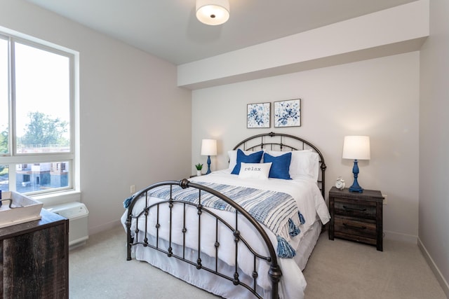 bedroom featuring light colored carpet