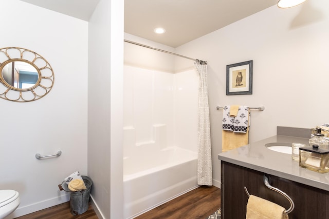 full bathroom with shower / bath combination with curtain, hardwood / wood-style flooring, vanity, and toilet