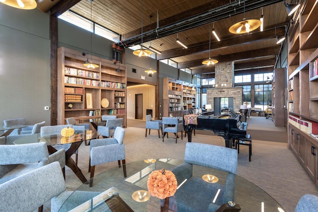 carpeted living room with wood ceiling, beam ceiling, and a high ceiling