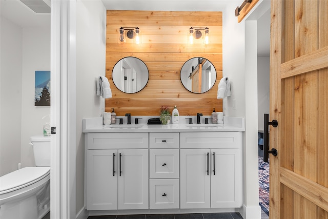 bathroom with dual sinks, tile floors, toilet, and large vanity