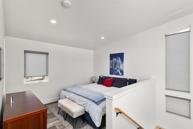 bedroom with multiple windows and wood-type flooring