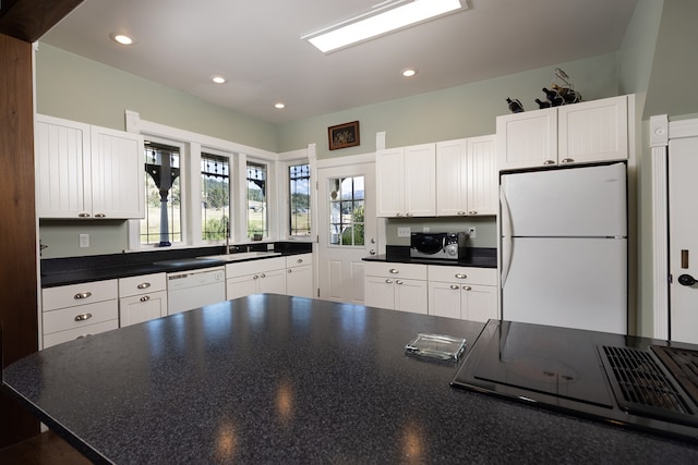 kitchen featuring white appliances and white cabinetry