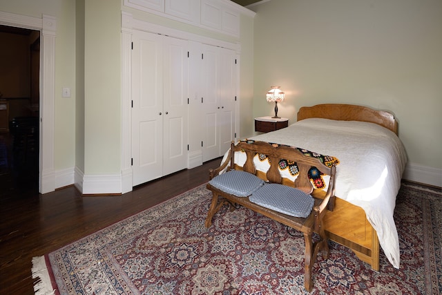 bedroom with a closet and dark hardwood / wood-style flooring