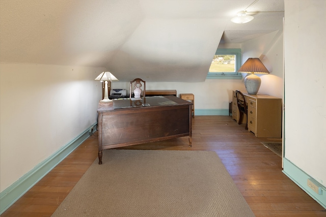 office area featuring dark hardwood / wood-style floors and vaulted ceiling