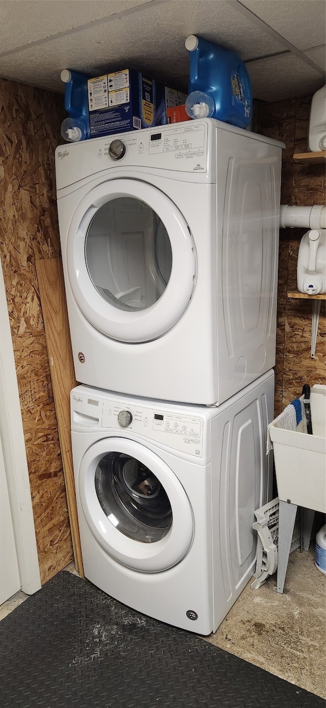 washroom featuring stacked washing maching and dryer