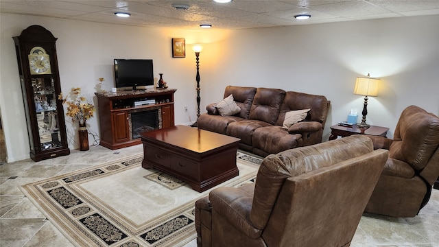 tiled living room featuring a drop ceiling