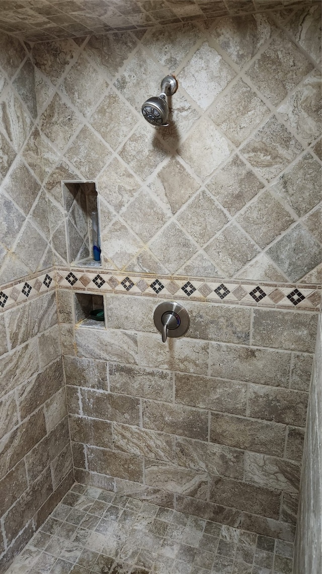 bathroom with tiled shower