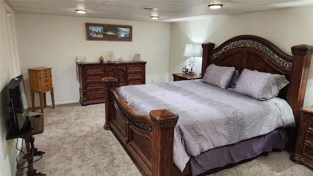 bedroom with light carpet and a drop ceiling