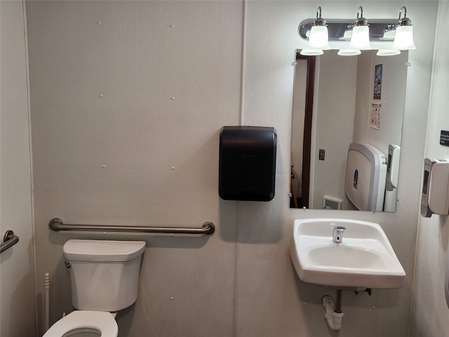 bathroom featuring sink and toilet