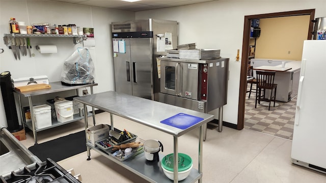 kitchen featuring high quality fridge, white fridge, and light tile flooring