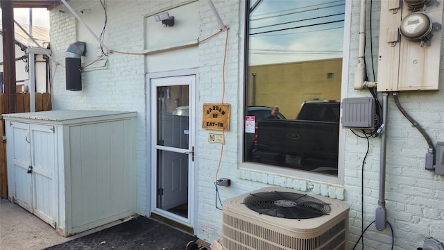 doorway to property featuring central air condition unit