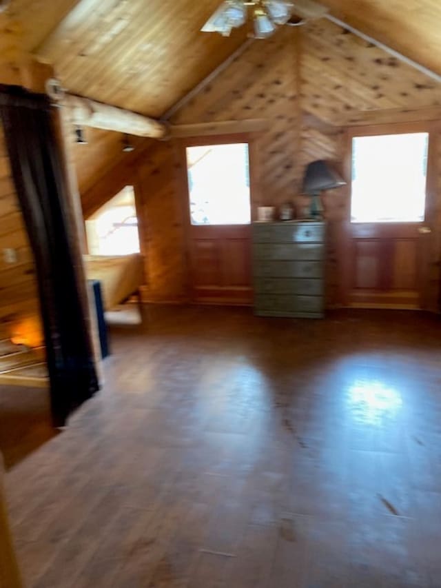 additional living space with wooden walls, wooden ceiling, and vaulted ceiling