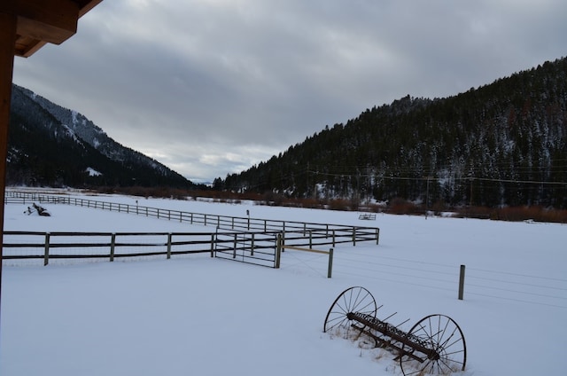 snowy yard with a mountain view