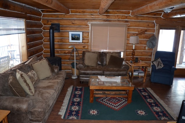 living room featuring a wood stove, wooden ceiling, log walls, beamed ceiling, and dark hardwood / wood-style flooring