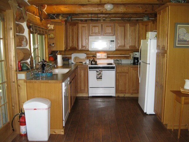 kitchen with dark hardwood / wood-style flooring, white appliances, beam ceiling, and sink