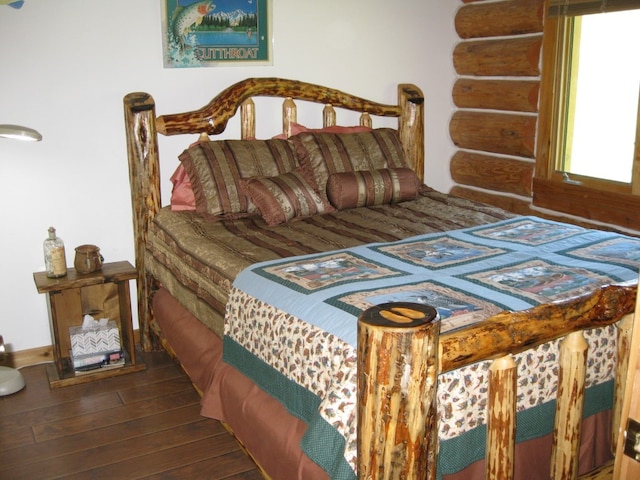 bedroom with dark hardwood / wood-style floors