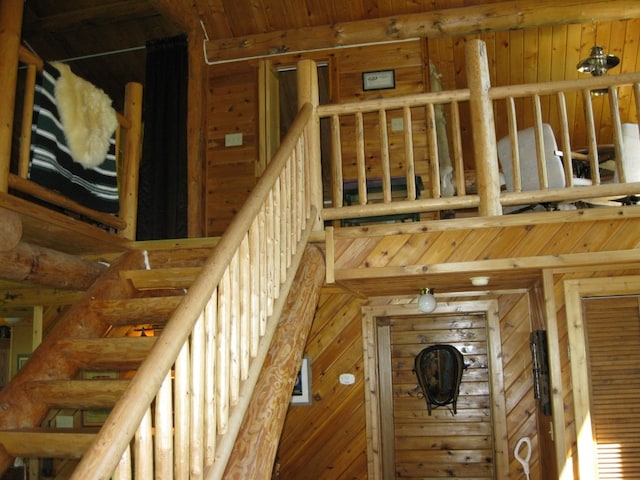 stairs featuring wooden walls