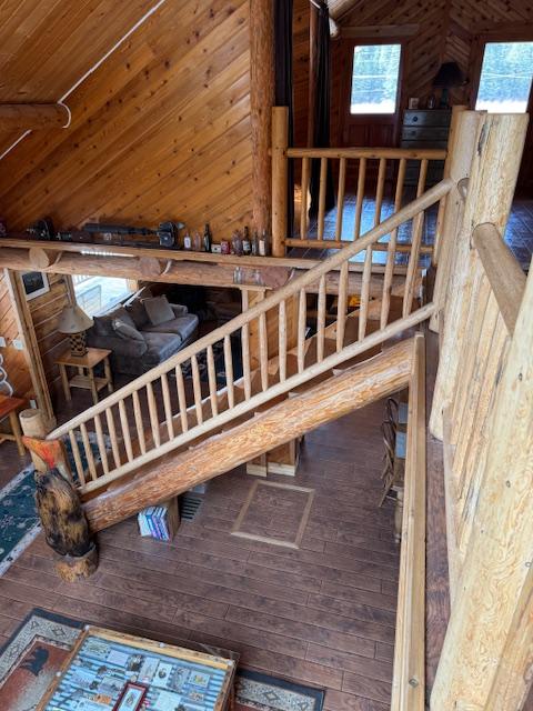 interior space featuring wooden ceiling, wooden walls, and wood-type flooring