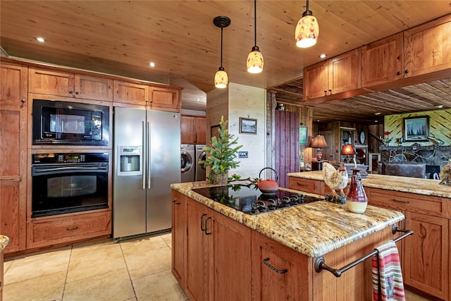 kitchen with black appliances, pendant lighting, wooden ceiling, independent washer and dryer, and a center island