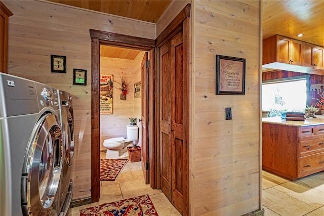 washroom with light tile patterned flooring, wood ceiling, and wood walls