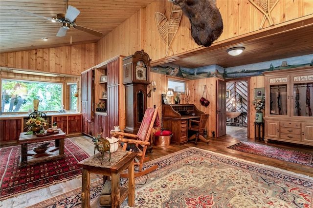 interior space with high vaulted ceiling, wood-type flooring, wooden walls, ceiling fan, and wood ceiling