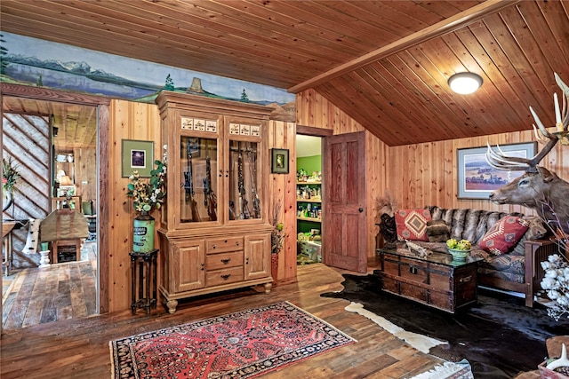 bedroom featuring vaulted ceiling with beams, wood walls, wooden ceiling, and dark wood-type flooring