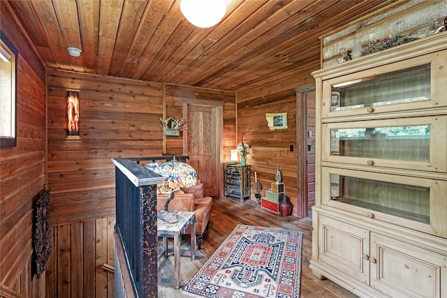 sitting room featuring wooden walls and hardwood / wood-style floors