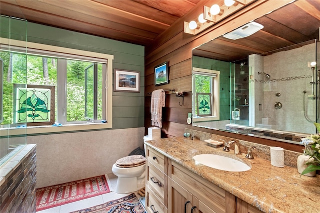 bathroom featuring vanity, wooden ceiling, tile patterned floors, toilet, and a tile shower