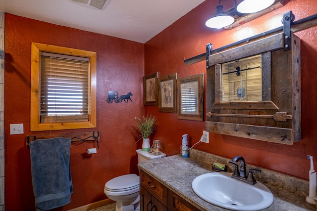 bathroom featuring large vanity and toilet