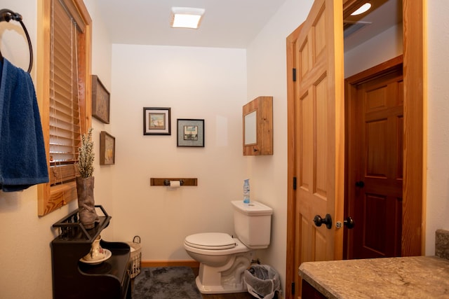 bathroom featuring toilet and vanity